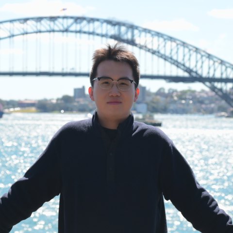 Zhikang Niu at Sydney Harbour, with the Opera House and the Harbour Bridge behind him